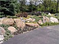 <b>Custom Natural retaining wall</b><br>Picture of natural rock retaining wall construction.